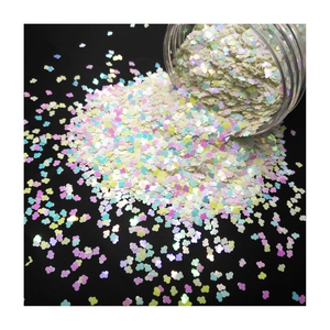 Cloud shaped iridescent white glitter flakes in a bottle for nail art and DIY crafts