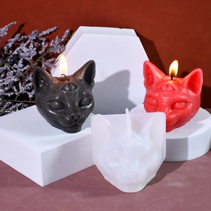 Three-eyed cat silicone candle mold with finished black and red gothic cat ornaments