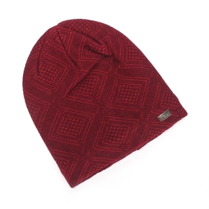 Detail of dark red beanie featuring textured diamond knit pattern and metal logo plate