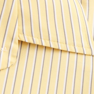 Close-up of yellow and white vertical striped shirt showing detailed collar stitching