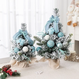Mini flocked pink Christmas trees with blue bows and ornaments for tabletop decoration