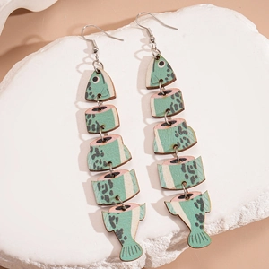 Artistic fishbone wood earrings with mint green texture on textured white stone background