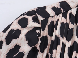 Detailed view of leopard print fabric with pleated texture and exquisite shoulder ruching