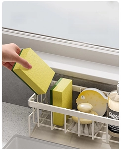 Close-up of kitchen sink organizer with slope drain tray for sponge and brush storage