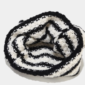 Detailed texture of black and white striped knit beanie with thick woolen yarn finish