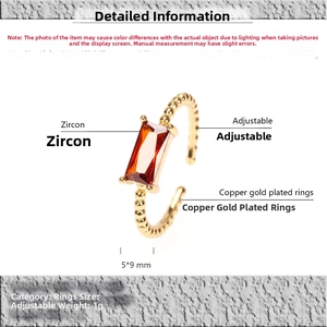 Detailed view of adjustable 18K gold plated twisted ring with 5x9mm red zircon gemstone