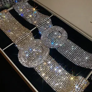Luxurious gold and silver wide rhinestone chokers with oval buckle on black velvet display