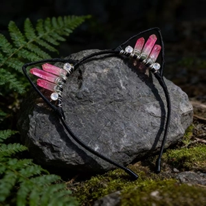 Close-up of pink and clear crystals hand-wrapped on a black cat ear headband