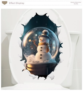 Sticker 3D boule de neige avec bonhomme de neige sur un abattant de WC blanc