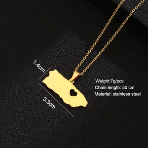 Macro detail of Puerto Rico map pendant with heart cutout on black textured background