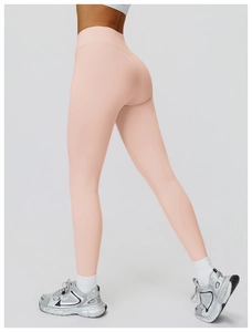 Detail of peach pink high waisted yoga leggings showing fit and peach butt lifting design