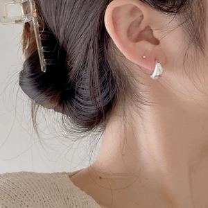Close-up of S925 sterling silver U-shaped earrings with minimalist zircon inlay