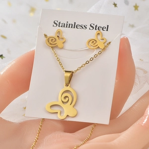 Detail of gold butterfly jewelry set with necklace and earrings made of stainless steel