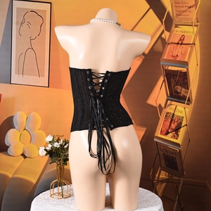 Detail of black corset back with criss-cross lace-up ties and subtle shimmer fabric