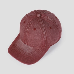 Detail view of washed vintage red denim baseball cap with premium stitched eyelets