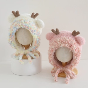 Detail of plush reindeer earflap hats for kids with soft faux fur and tie straps