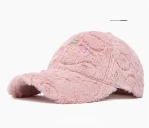Close-up of pink faux fur baseball cap featuring colorful textured floral embroidery detail