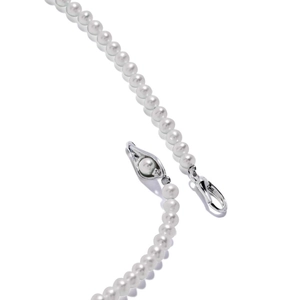 Detail of 925 silver lobster clasp and eye-shaped charm with pearl on a necklace
