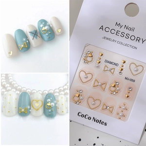 Golden embossed butterfly and heart nail charms with pearls for elegant manicure art