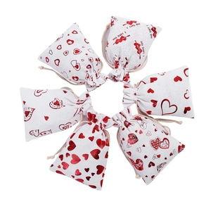 Set of 6 cream linen drawstring wedding favor bags with red heart patterns and love prints