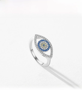 Detail of s925 silver Evil Eye ring featuring blue gemstones and pavé set white zircons