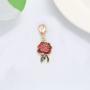 Close-up of red and black rose flower charm with gold metal edges and lobster clasp