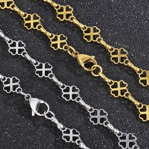 Detailed shot of hollowed-out clover necklace chains in gold and silver stainless steel