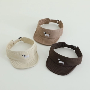 Detailed view of adjustable buckles and dachshund embroidery on sun visors
