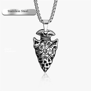 Detailed view of vintage stainless steel arrowhead pendant with Viking compass engraving
