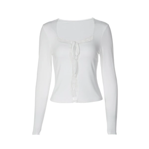 Close-up of white slim-fit top featuring delicate lace trim and ribbon tie detail