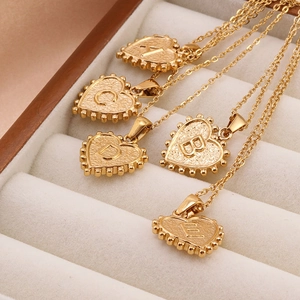 Minimalist gold heart letter necklace set in stainless steel displayed in jewelry box