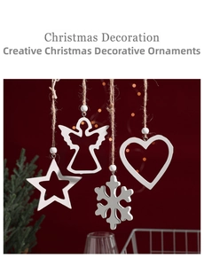 Detail of four white wooden Christmas ornaments including star, angel, and snowflake