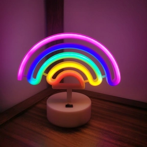 Rainbow LED neon light with white base glowing on a wooden table for home decoration
