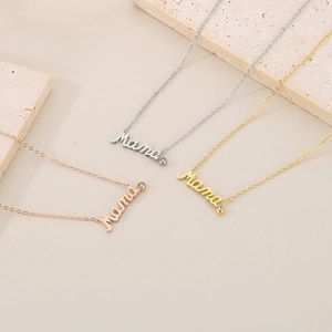 Detailed view of Mama pendant necklaces in silver, gold, and rose gold with diamond accents