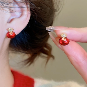 Close-up of red bead earrings with gold-plated lucky bag design and sparkling zircon stones