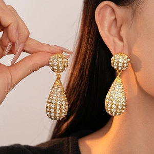 Elegant gold drop earrings with striped metal and rhinestones for a vintage luxury look