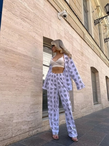 Women's 2-piece lounge set with animal print, featuring long sleeve shirt and wide pants