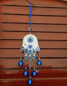 Detail of Hamsa Hand and Evil Eye hanging ornament with five blue metal bells