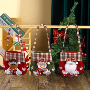 Three Christmas gift bags with 3D Santa, Snowman and Reindeer on a wooden stand
