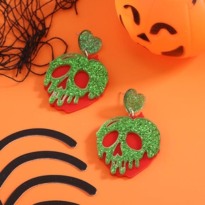 Boucles d'oreilles squelette Halloween avec paillettes vertes et base rouge sur orange