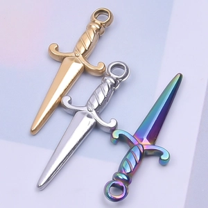 Macro detail of sword-shaped charms in gold, silver, and rainbow steel plating