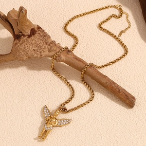Detail of 18K gold plated angel pendant with sparkling crystals on a woven chain
