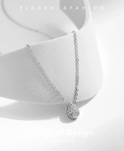 Close-up of elegant S925 silver water drop pendant necklace with pavé-set cubic zirconia