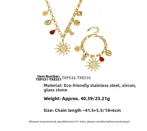 Detail of PVD gold plated stainless steel jewelry set with sun and bear charms