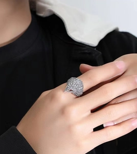 Close-up of vintage eagle head ring with red accents and detailed feather texture