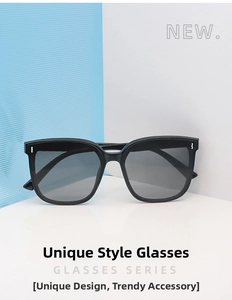 Detail of square black sunglasses frame with grey gradient lenses and metal accents