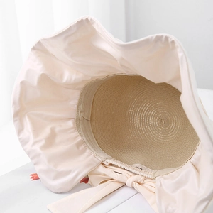Women's UV protection straw hat with wide fabric brim and large bow detail