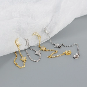 Detailed view of S925 sterling silver star and moon chain earrings in gold and silver