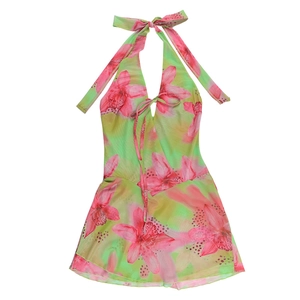 Detail of tropical green floral dress showing halter neck ties and pink orchid print