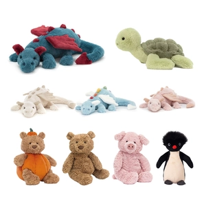 Collection of plush animal toys featuring dragons, bears, and penguins on white background